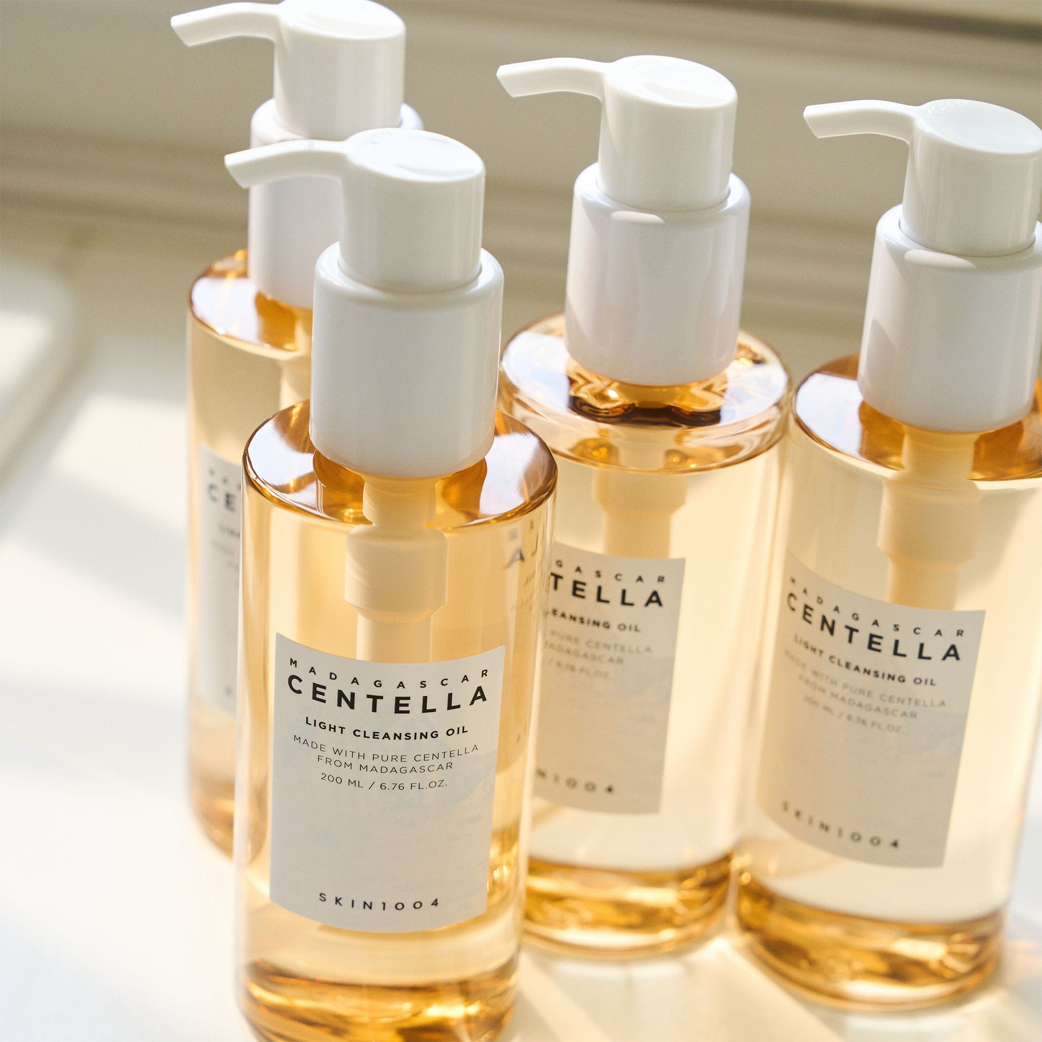 Skin1004 - Centella Botanical Cleansing Oil bottles showcase a luxurious, plant-powered formula for effortless makeup removal.